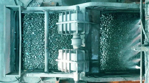 Copper ore is moving through the grinding machine in a top view Stock Footage 158159501