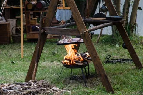 Copper pan on fire with chicken during a Middle Ages historic reenactment Stock Photos