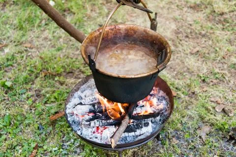 Copper pan on fire with soup during a Middle Ages historic reenactment Stock Photos