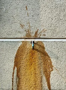 A copper pipe and rust on a concrete wall Stock Photos