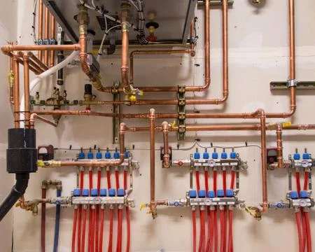 Copper pipes on a wall Stock Photos