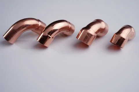 Copper plumbing fitting adapter copper pipe accessories isolated at white Stock Photos