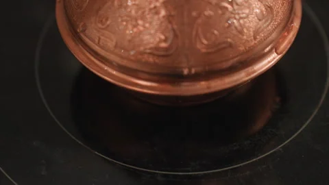 Copper pot warming. Slow heating of copper cezve in stove. Intimate morning Stock Footage 342065088