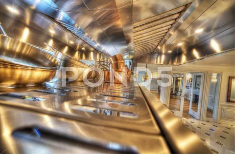 Copper pots in a stainless steel kitchen Stock Photos