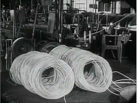 Copper is processed and coils are produced at an Auto-lite plant in the 1940s. Video stock 74965837