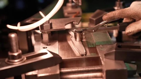 Copper resistance welding electrodes clamp a scissor blade inside a bright Stock Footage 346738146