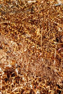 Copper shavings. Copper processing on CNC machines in production. Stock Photos