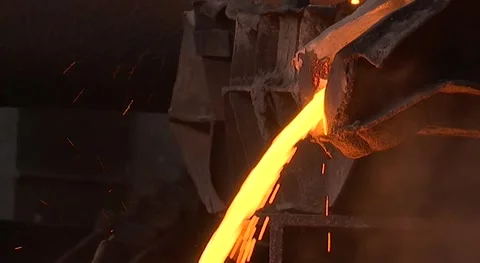 Copper smelter, molten copper flows and leaks into the vessel and molds Stock Footage 131559300