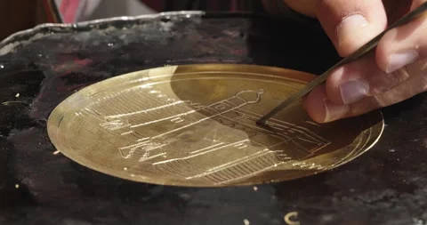 Copper-smith engraving patterns on a metal plate. Handmade Uzbek souvenirs Stock Footage 276846141