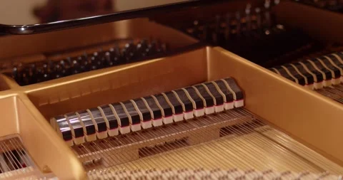 Copper strings inside a piano. Close up Stock Footage 280404111