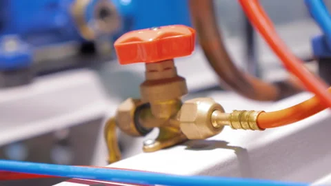Copper tap with a red valve in a polyurethane pipeline Stock Footage 98210124
