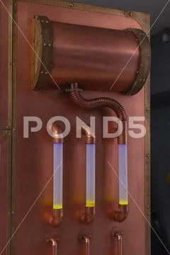 Copper tubes with liquid and lighting Stock Photos