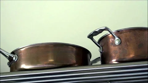 Copper utensils on the rack in the kitchen. Video stock 132618787