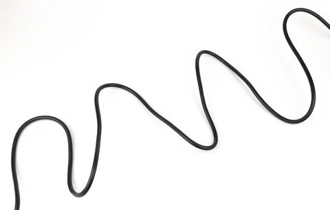 Copper wire in black insulation on a white background. Power cable. 库存照片
