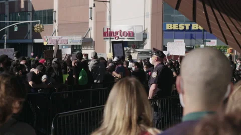 Cops behind fence at a BLM protest in downtown Brooklyn Stock Footage 138385590