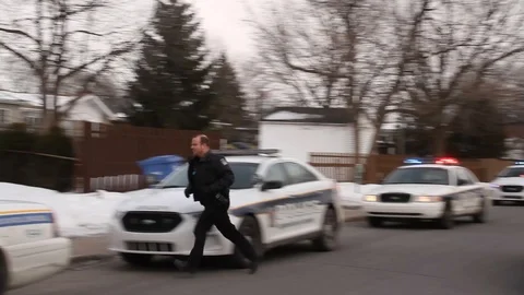 Cops exiting car while still driving with sirens during backup incident Stock Footage 85706125