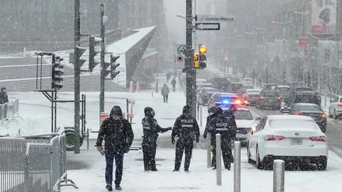 Cops with protective masks standing in snowfall near covid detection centre Stock Footage 126994284