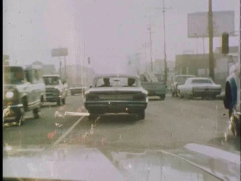 Cops stop a car and make an arrest in Oakland in the 1970s. Stock Footage 75281881