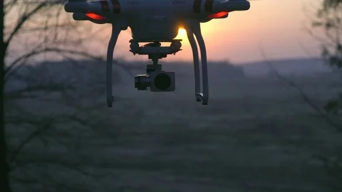 Copter drone Phantom flies at sunset Stock Footage 74282803