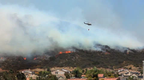 COPTER DROPS WATER ON BRUSH FIRE Stock Footage 22997662