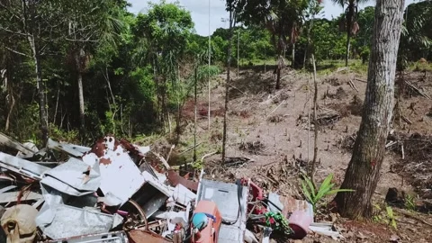 Copter flies around large accumulations of garbage waste, smokes Stockbeeldmateriaal 230700556
