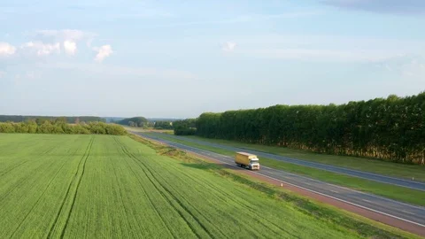 A copter flies back over the fields with crops. Stock Footage 116805749
