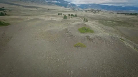 The copter flies high in the mountains over hills, rivers and forests. Cloudy Video stock 278367876