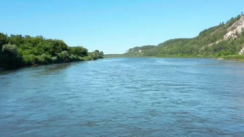 The copter flies in the middle of the river. 스톡 동영상 113695879