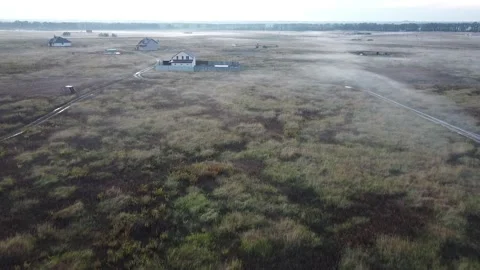 Copter flies over the field. in the evening. smoke from the ground, the haze Stock Footage 141893780