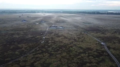 Copter flies over the field. in the evening. smoke from the ground, the haze Stock Footage 141893869