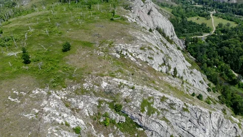 A copter flies over the rocks. Stock Footage 129508607
