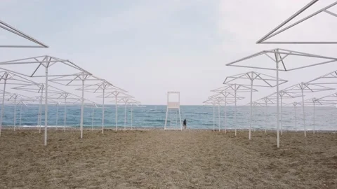 Copter flies off the rescue tower, between the umbrellas from the sun Stock Footage 181451487