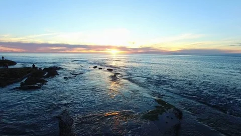 Copter flight above ocean at sunset Stock Footage 81039954