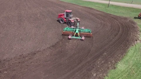 Copter flight over the field and a tractor stock footage, aerial view Stock-Footage 78155676