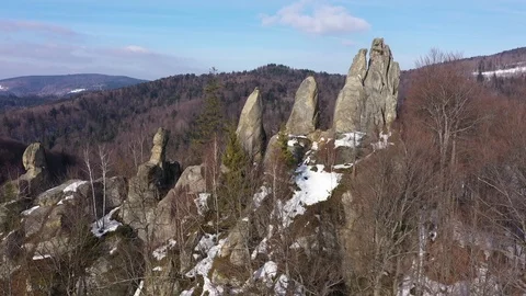 Copter flight throw huge rocks above winter mountains 4k Stock Footage 117191702