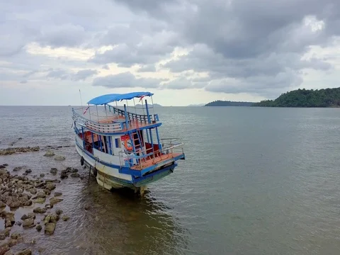 Copter Flying Over boat on a stone aground Ko Kut Island overcast Stock Footage 75985229