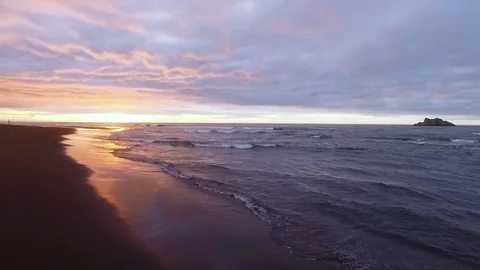 Copter flying at sunset over the sea to the mountains. Flew the ocean at sunrise Stock Footage 72693286