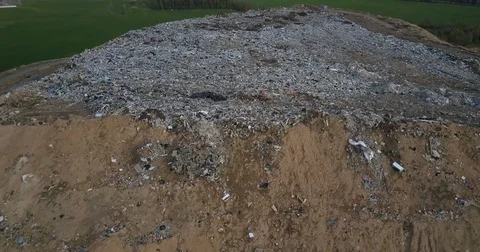 Copter getting up above the city dump. Aerial view of the big pile of trash and Stock Footage 76109155