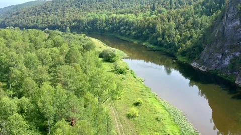 Copter goes down to the riverbank. Stock Footage 114976335