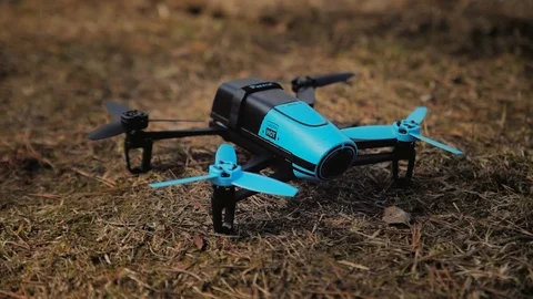 At the copter on the ground the blades begin to rotate, it disperses the spruce Stock Footage 97410764