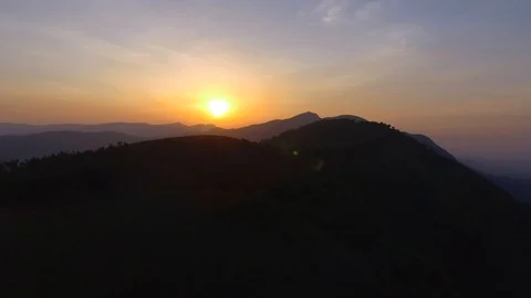 Copter moving across a forest on a mountain during sunset 動画素材 90885326