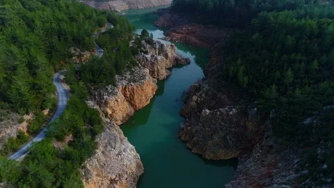 Copter moving up during flight over beautiful blue Dim River surrounded by Stock Footage 86531471