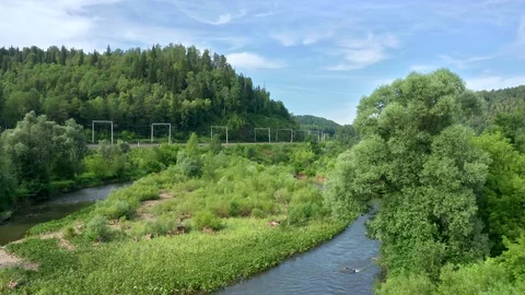 A copter rises and flies over a river valley. Stock Footage 119068693