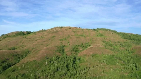 A copter rises up the side of a mountain. Stock Footage 119071482