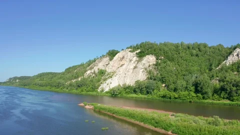 The copter rises smoothly from the surface of the river Stock Footage 119075595