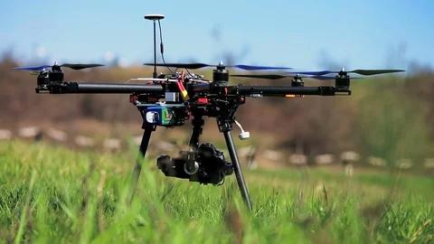 Copter stands on the ground and prepares for take-off. Stock Footage 75826573