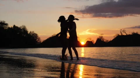 Copuple in love hug at a tropical beach at sunset Stock Footage 106939925
