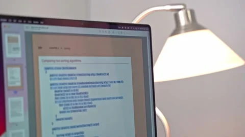 A copy of computer source code is being made from an online book. Sample Stock Footage 213123685