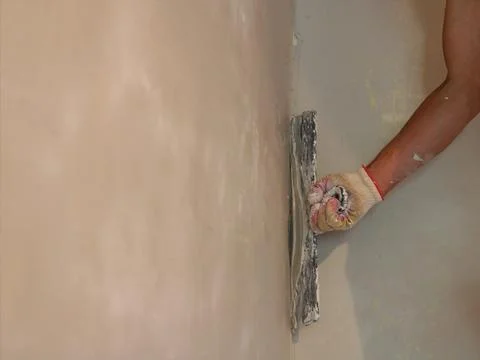 Copy-paste on plastered wall with builder's hand Stock Photos