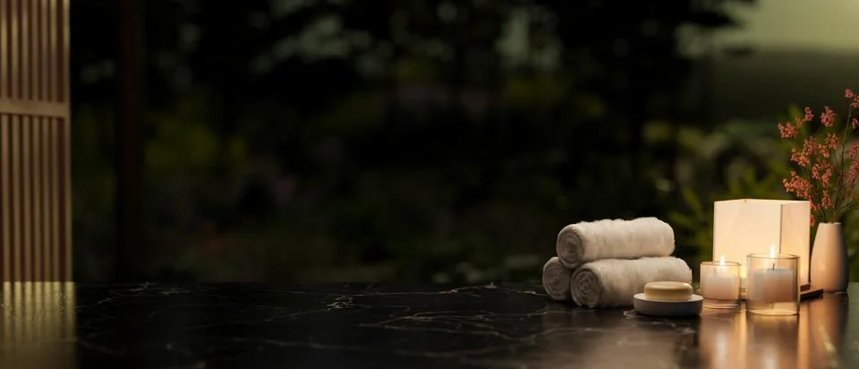 A copy space on a black marble table featuring towels, candles, a soap, and.. Stock Illustration